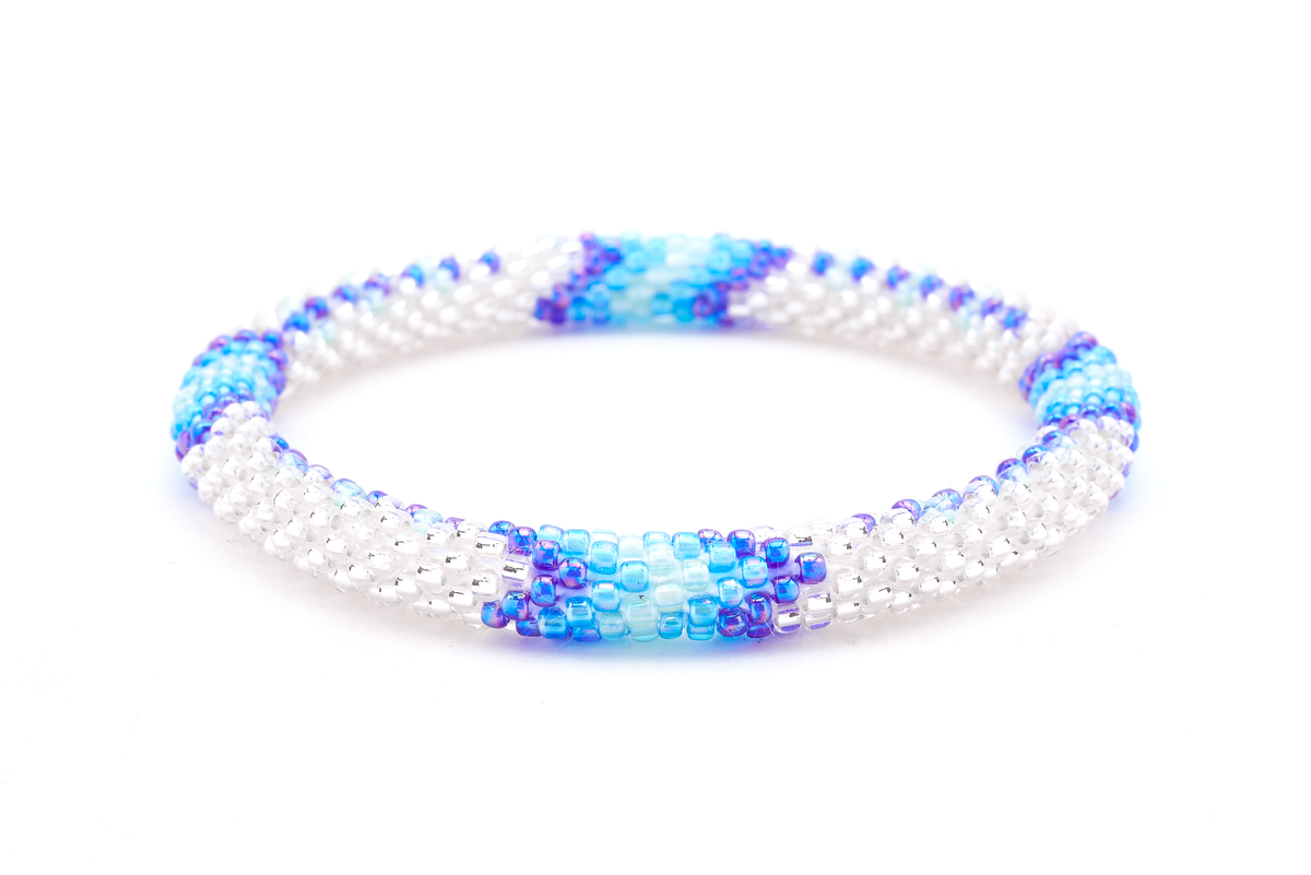 Handmade beaded friendship bracelet with clear, iridescent blue, blue, and light blue glass beads. Crafted by artisans in Nepal for Sashka Co.