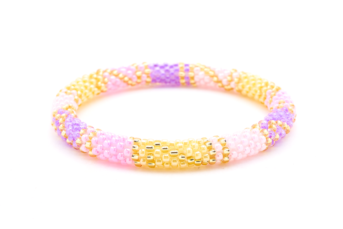 Handmade beaded friendship bracelet with pink, light pink, yellow, orchid, and gold glass beads. Crafted by artisans in Nepal for Sashka Co.