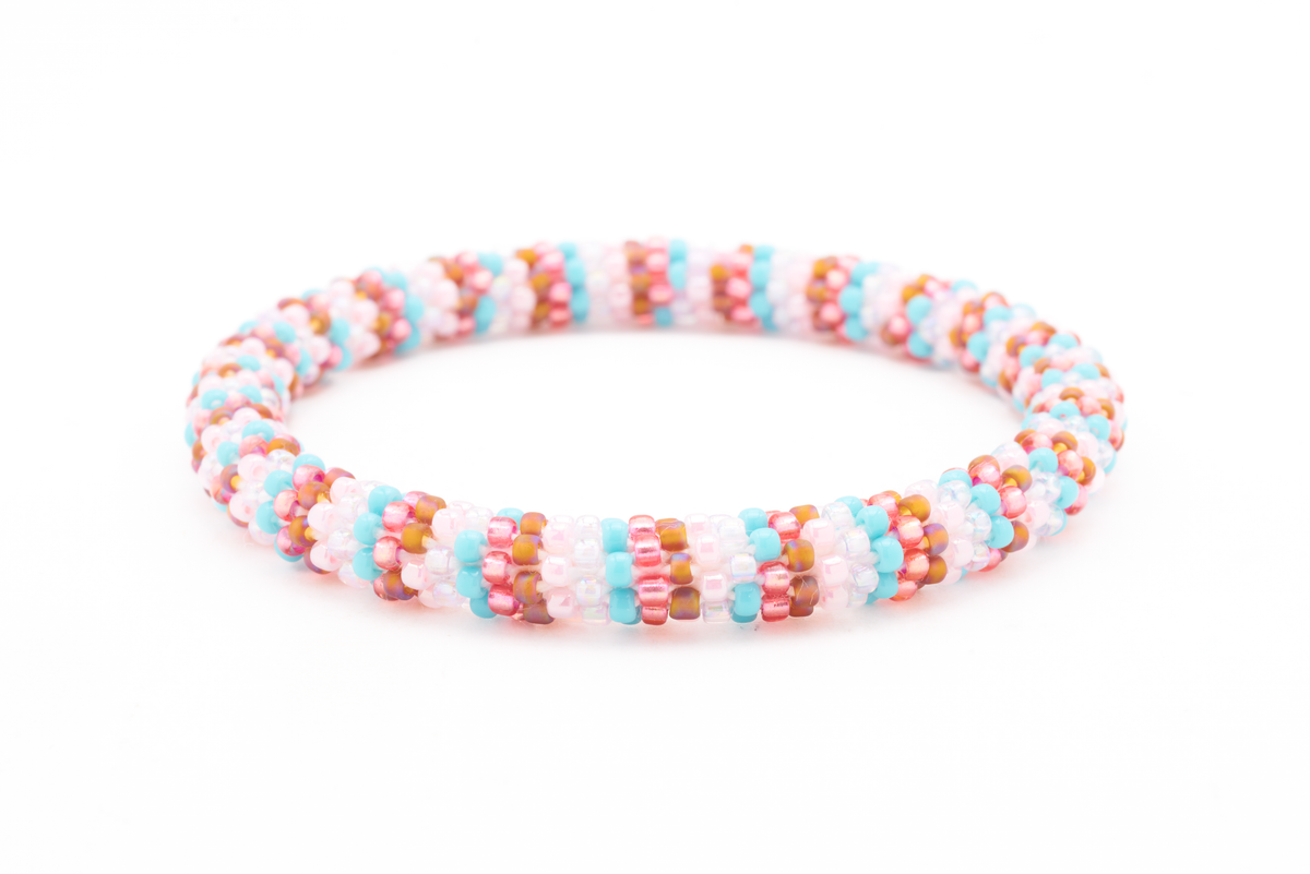 Handmade beaded friendship bracelet with turquoise, rose red, iridescent brown, pink, and white glass beads. Crafted by artisans in Nepal for Sashka Co.
 